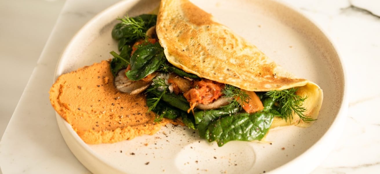 Spinach omelette on a plate with toast